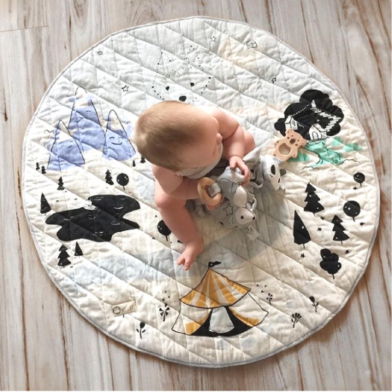 baby playing on a circular mat