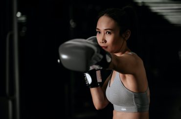woman with black gloves boxing