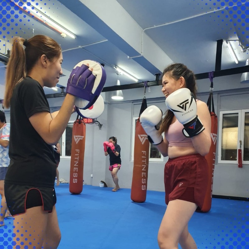 two women boxing in classes in Singapore