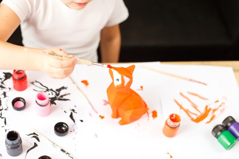 child painting clay figurine 