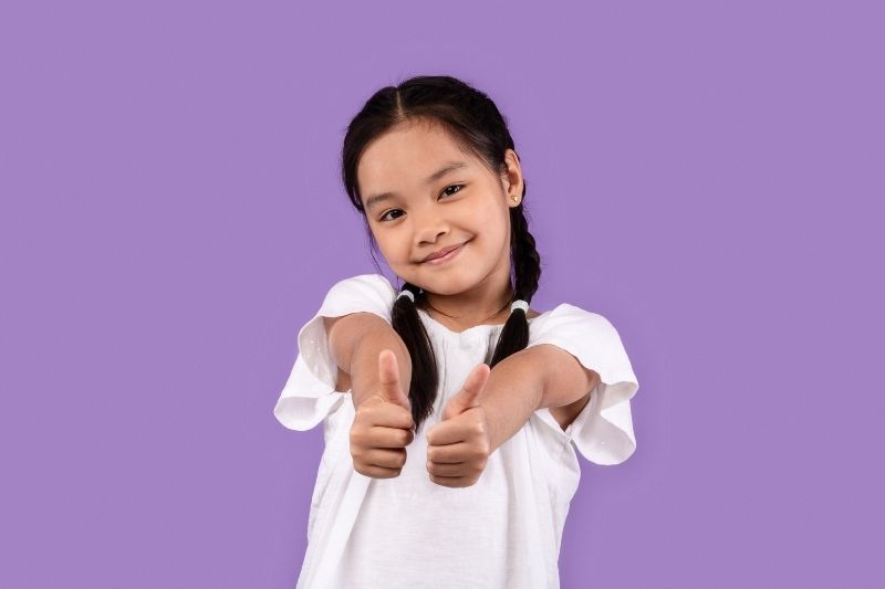 Young girl thumbs up 