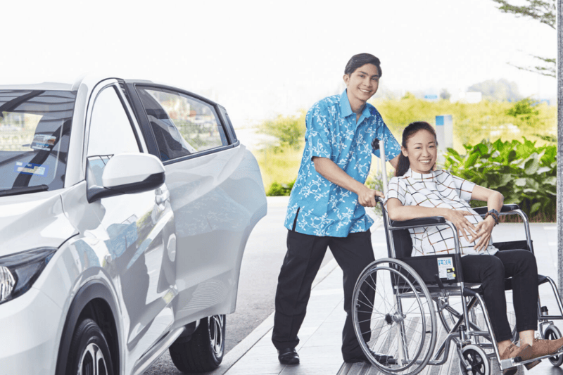 Columbia Asia Hospital Male Hospital Staff Pushing Pregnant Woman on wheelchair