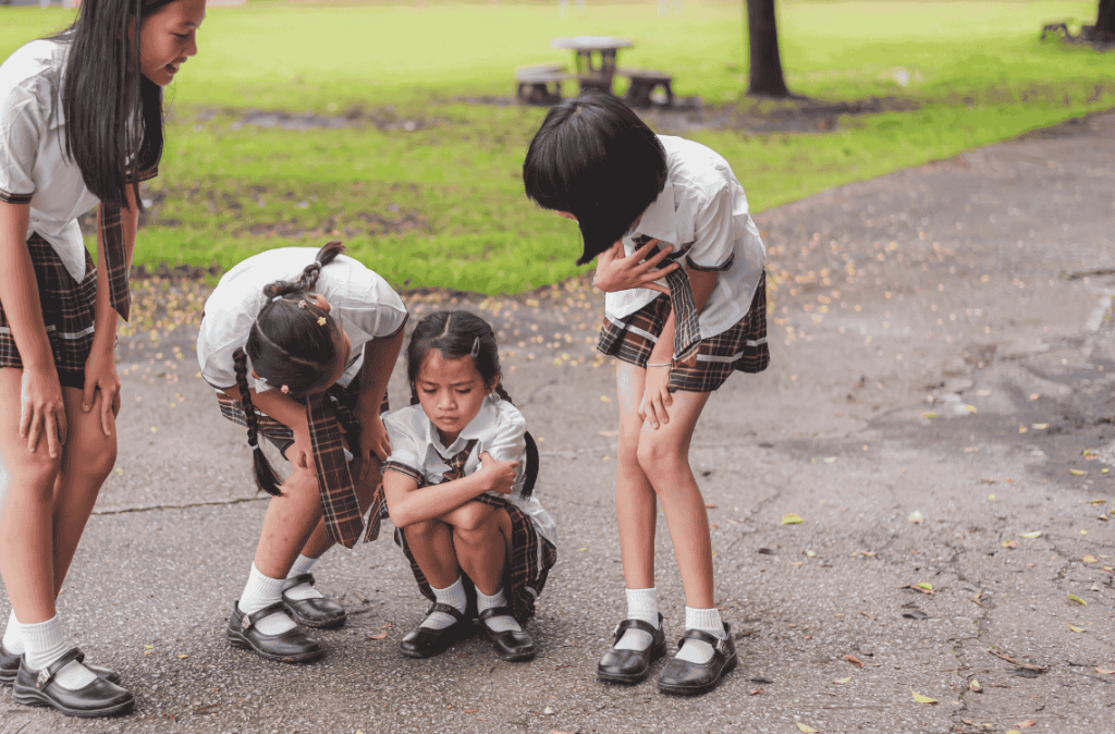A primary school girl in a school uniform feels uncomfortable and unwell.She is being cared for by her friend and seniors at school,They spent their childhood days learning, friendship, help, support.