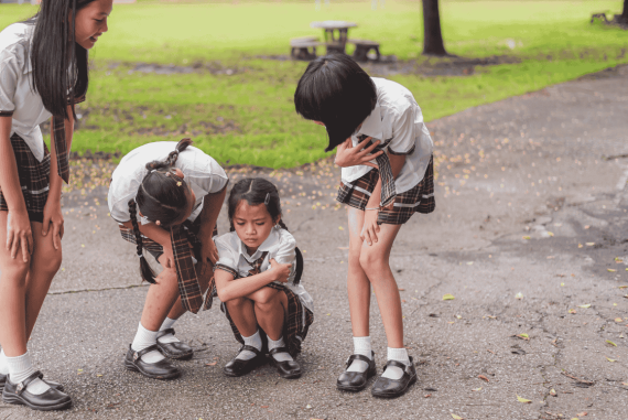 A primary school girl in a school uniform feels uncomfortable and unwell.She is being cared for by her friend and seniors at school,They spent their childhood days learning, friendship, help, support.